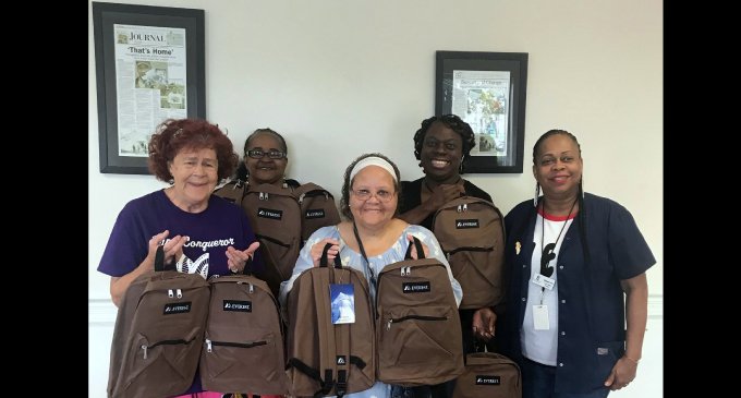Quality Independent Living delivers book bags for the homeless